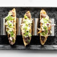 Korean Beef Tacos · Three Crispy Wonton Shells filled with Bulgogi Marinated Beef and Asian slaw, topped with Gr...