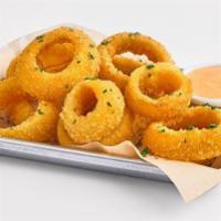 Onion Rings · Lightly battered and fried onion rings, served with a side of roasted red pepper aioli.