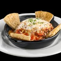 Baked Lasagna · A hearty classic, made in-house, featuring layers of pasta filled with ground beef and ricot...