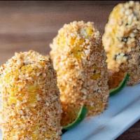 Street Corn · Three mini corn cobs topped with  crumbled queso Cotija, and chile-lime salt.