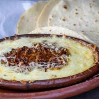Queso Flameado · Our chef Alex recommends. Melted cheese, served with Mexican chorizo and fresh flour tortill...
