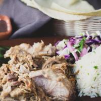 Carnitas · Tender slow-cooked pork served with black beans and cilantro rice.