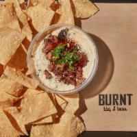 Brisket Queso · By Burnt BBQ & Tacos. Brisket, Cheese, Cilantro, BBQ sauce, Cotija Cheese with housemade tor...