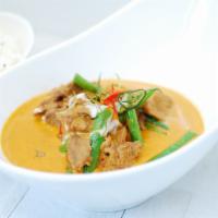 Panang Curry · Spicy. Thai herbs and spices blended in chili paste, hint of kaffir lime leaves and bell pep...