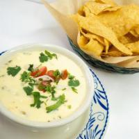 Queso Poblano · melted chihuahua cheese, pepper jack, queso blanco, diced roasted poblano peppers, nopales, ...