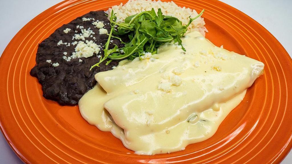 Enchiladas Queso Blanco · chihuahua, monterrey jack & munster cheese, housemade white corn tortillas, signature queso poblano