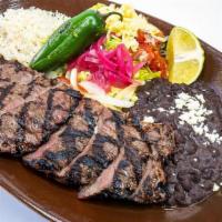 Arrachera · mesquite grilled skirt steak, sauteed bell peppers & onions, rice, beans, side of guacamole ...
