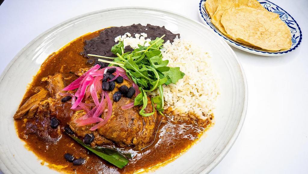 Cochinita Pibil · yucatan-style braised pork, tangy orange, achiote sauce, whire rice, black beans, pickled red onions, habanero salsa, served with housemade corn totillas