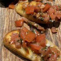 Bruschetta Pomodoro · Roma tomatoes, fresh basil and olive garlic sauce.