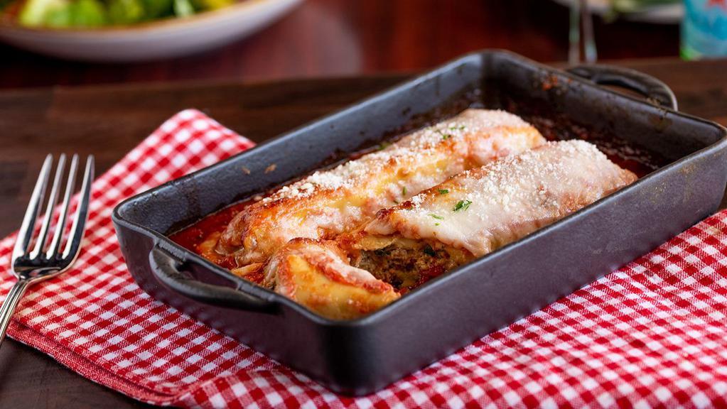 Chicken Manicotti · Fresh pasta stuffed with chicken, kale, and spinach, topped with Russo’s marinara and mozzarella.