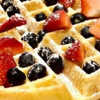 Patriot Waffle Combo · A golden Belgian waffle topped with fresh berries and powdered sugar served with eggs cooked...