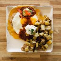 Huevos Rancheros · A flour tortilla layered with refried beans, Jack and Cheddar cheese and two eggs any style....