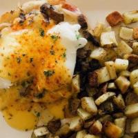 Parisian Benedict · Two poached eggs with smoked ham, house-roasted cremini mushrooms and melted Swiss piled hig...