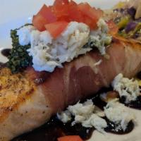 French Quarter Salmon · Prosciutto wrapped and grilled, topped with fresh basil pesto, chilled crab and fresh tomato...