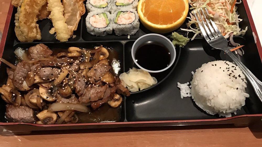 Beef Teriyaki Bento Box · Served with miso soup, salad, steamed rice, four pieces California roll, shrimp, veggie tempura, and fried gyoza.