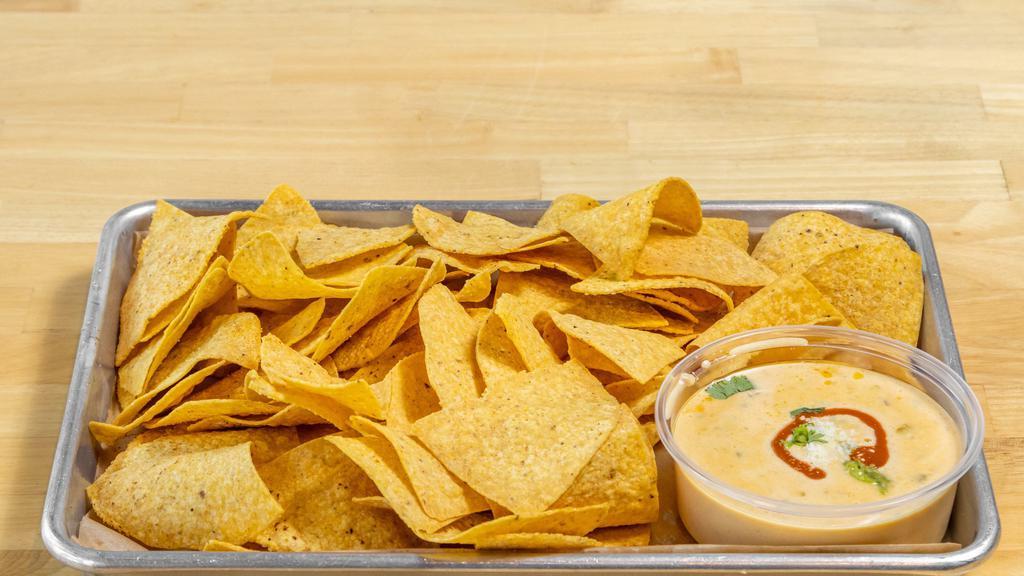 Chips & Queso · 8 oz. homemade queso served with our fresh, homemade chips! We fry a fresh batch of chips for every order!