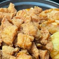 Chicken Tteok-Bokki · Spicy rice cake with boneless fried chicken on top.
