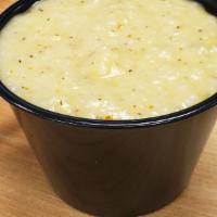 Cheesy Grits · 4 oz. of fresh made grits with cheddar cheese and a little spice kick