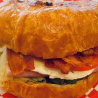 Croissant Sandwich  · Warm toasted Croissant with your choice of either (ham, turkey, or sausage patty) and cheese...