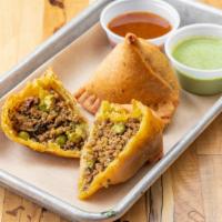 Beef Samosa · Two pastries filled with ground beef and aromatic spices.