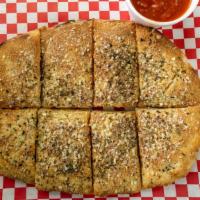 Garlic Parmesan Bread · Our fresh dough twisted and infused with garlic and herbs. Served with marinara.