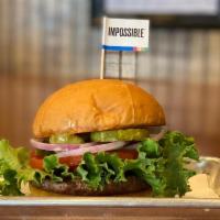 Scotty P'S Impossible™ Burger · It's MEAT MADE FROM PLANTS.  Scotty P's Impossible Burger with Lettuce, Tomato, Pickles, Oni...