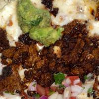 Queso Fundido (Chorizo) · A delicious blend of our  homemade queso and Oaxaca queso topped with the finest chorizo, gu...