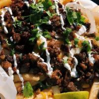 Fajita Fries · Crispy seasoned waffle fries topped with our flavorful carne asada steak, melted queso, lett...