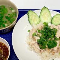 Hainanese Chicken Rice · Steamed chicken over Hainanese rice, and Hainanese sauce on the side.