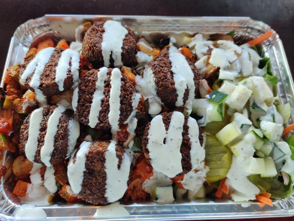 Falafel Platter · New york street cart style platter with falafel lettuce and served over seasoned rice; topped with our magic white sauce. spicy available.