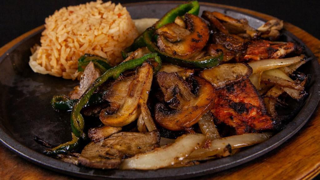 El Pollo Con Hongos · Marinated grilled chicken breast topped with sautéed mushrooms, onions and poblano peppers. Served with cilantro rice, bean soup, and chef's salad.