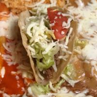 Mexican Plate · Two cheese enchiladas, one taco, one chile relleno served with rice, and refried beans.