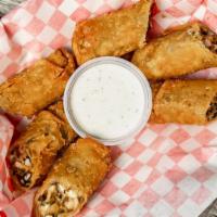 Southwest Chicken Egg Rolls · Grilled chicken, corn, black beans and chopped peppers rolled into a flour tortilla and frie...