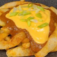 Chili Cheese Fries · Large serving of our house fries drizzled with nacho cheese, Texas style chili and green oni...