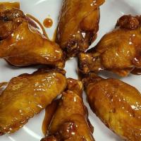 6 Piece Traditional Wings · Six traditional bone-in chicken wings covered in your choice of sauce or seasoning.