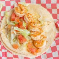 Grilled Shrimp Taco · Grilled shrimp and your choice of lettuce and tomatoes or onions and cilantro.