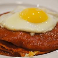 Enchiladas Montadas · Enchiladas topped with two eggs served with hash-browns and beans.