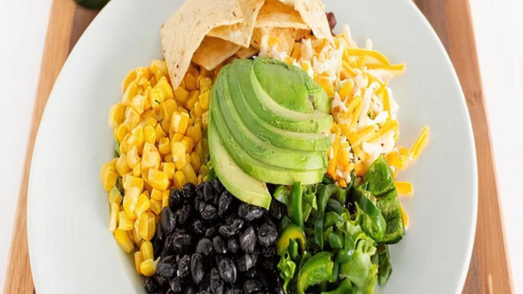 Southwest Salad · Fresh spring mix & baby arugula, black beans, poblano peppers, avocado, corn, artisan cheese blend, corn tortilla chips, southwest vinaigrette