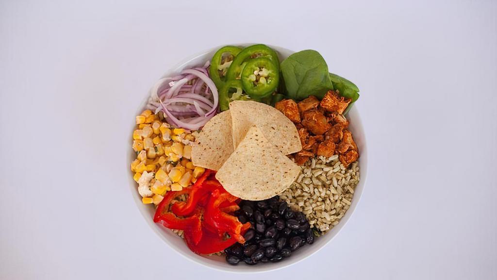 Fiesta Bowl · Cilantro lime brown rice, spicy chicken, spinach, elote street corn, red onion, red peppers, jalapeños, black beans and corn tortilla chips with Avocado Cilantro dressing