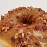 Maple Bacon Donut · Maple iced donut with bacon crumbles on top.