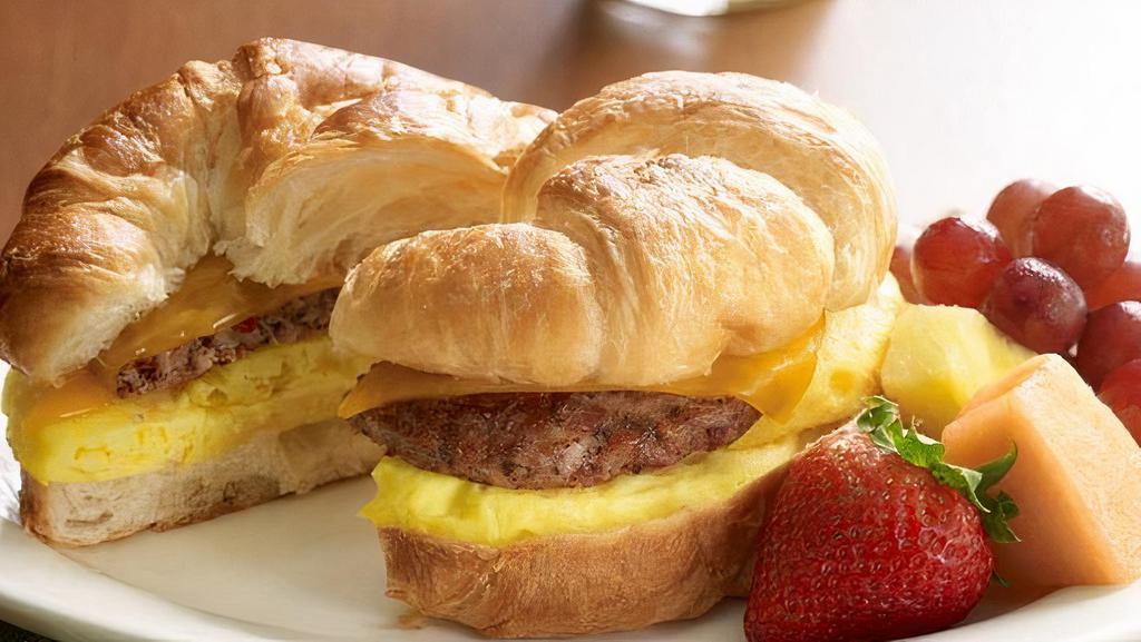 Sunshine Croissant · Fresh-cracked egg, melted cheddar and your choice of breakfast sausage, crispy bacon or nitrite-free ham, on an all-butter croissant.