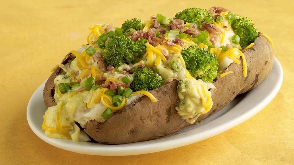 Spud Aubroc · One of our giant spuds loaded with Broccoli cheese soup, cheddar cheese, bacon bits, green onions, and steamed broccoli florets.