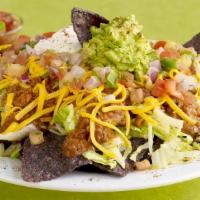 Taco Salad · Your choice of Chili, Southwest chicken chili, or Corn & Black bean mix served on a bed of l...