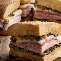 Whole Muffaletta · A New Orleans original! Grilled, crusty Muffaletta bread is spread to the edges with our fam...