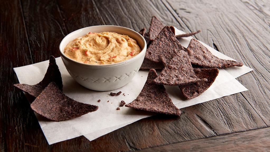 Blue Corn Chips & Hummus  · Order our hummus with chips and add zest to your meal! It’s made from mashed chickpeas, with the crave-appeal of roasted red bell peppers and sesame tahini.