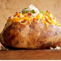 Family Plain Jane Bar · Giant baked potatoes wrapped hot and ready to serve. Toppings: cheese, sour cream, bacon and...