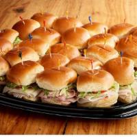 Deli Sliders Tray (3750 Cal) · Cold, mini sandwiches on potato slider buns; 12 Roasted Turkey Sliders & 12 Ham-Salami Slide...
