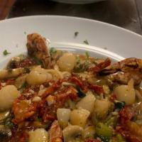 Pollo Caprino · Chicken, shrimp and crab meat sautéed with garlic and basil in a brandy cream sauce served o...