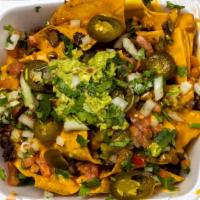 Nachos · Freshly made corn tortilla chips layered with refried beans, choice of meat, cheese and jala...