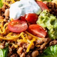 Taco Salad · Homemade edible flour tortilla bowl stuffed with refried beans, choice of meat, lettuce, che...